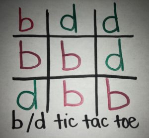 A tic tac toe board with letters b & d. 